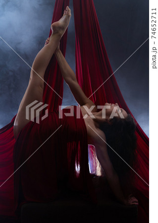 Concept of art, creativity and passion. Flexible woman on black background  74652711