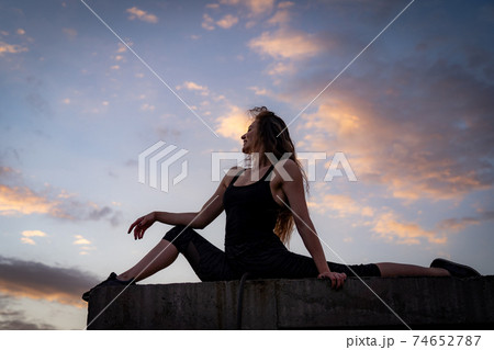 Female dancer on the edge of rooftop on the sky background. Concept of healthy lifestyle, talent and aspiration 74652787