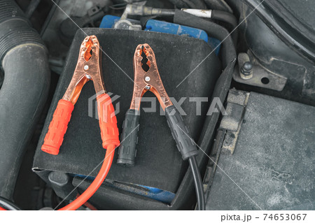 Jump cables on car low power battery. Jump cables on car low power battery. 74653067