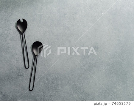 Salad serving utensils on gray stone,copy space 74655579
