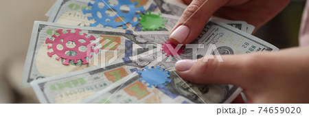Female hand holds one hundred dollar bills on pasted bacteria virus. Female hand holds one hundred dollar bills on pasted bacteria virus. 74659020