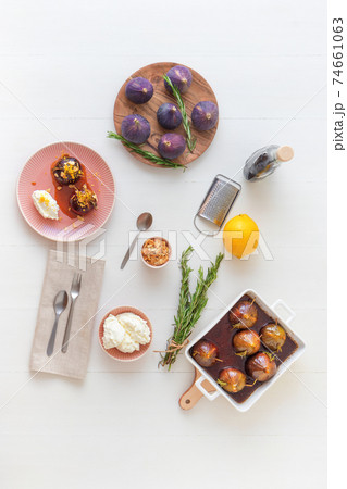 Caramelised figs with balsamic vinegar, rosemary, almonds and cottage cheese. Slow roasted homemade fruit dessert. White wooden table background. No people. Gordon Ramsey recipe. 74661063