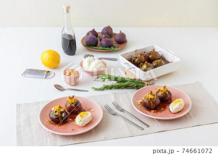Caramelised figs with balsamic vinegar, rosemary, almonds and cottage cheese. Slow roasted homemade fruit dessert. White wooden table background. No people. Gordon Ramsey recipe. Caramelised figs with balsamic vinegar, rosemary, almonds and cottage cheese. Slow roasted homemade fruit dessert. White wooden table background. No people. Gordon Ramsey recipe. 74661072