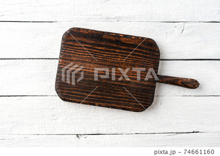 Empty cutting board on rustic wooden background. Top view Empty cutting board on rustic wooden background. Top view 74661160