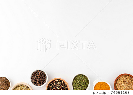 Overhead shot of seasonings in bowls isolated on white background with copyspace Overhead shot of seasonings in bowls isolated on white background with copyspace 74661163