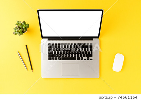 Modern office desktop with laptop with empty screen and business accessories. Top view 74661164