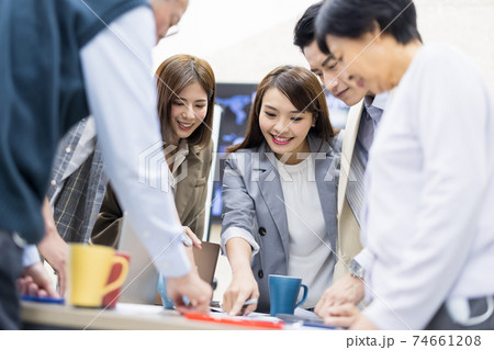 Coworkers discuss at table 74661208