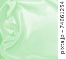 Smooth elegant green silk or satin luxury cloth texture as abstract background. Luxurious background design 74661254