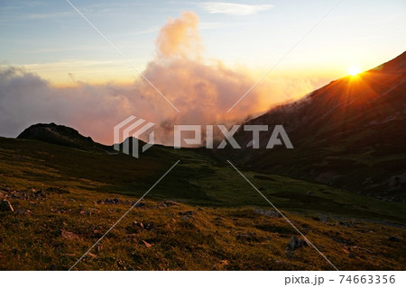 夏の白馬岳 頂上宿舎付近からの絶景 旭岳に沈む夕陽と朱色に染まる雲海 夏の白馬岳 頂上宿舎付近からの絶景 旭岳に沈む夕陽と朱色に染まる雲海 74663356