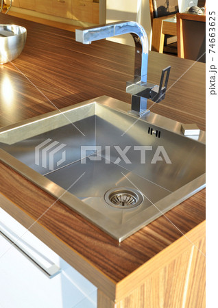 Interior of modern kitchen and stainless steel sink, tap and drain 74663625