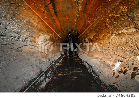 Large sewage tunnel with filth flowing out Large sewage tunnel with filth flowing out 74664385