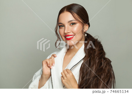 Celebrity brunette woman with makeup wearing white bathrobe. Morning routine Celebrity brunette woman with makeup wearing white bathrobe. Morning routine 74665134