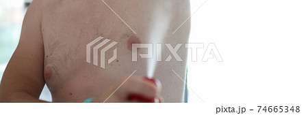 Man spray his armpits with spray. Man spray his armpits with spray. 74665348