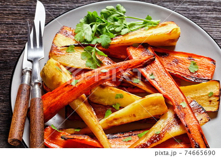 Moroccan roasted parsnip and carrot on a plate 74665690