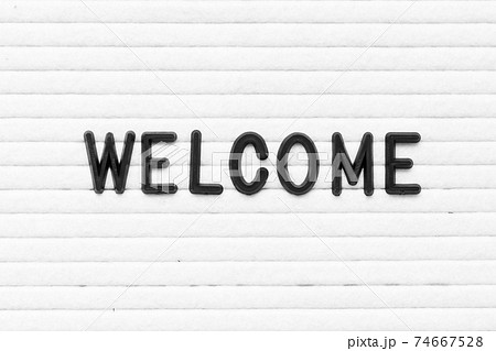 Black color letter in word welcome on white felt board background Black color letter in word welcome on white felt board background 74667528