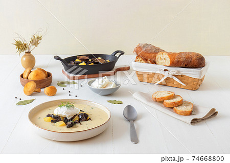 Kulajda, favourite tasty Czech mushroom soup. Thick creamy soup with fresh forest mushrooms, poached eggs and potatoes. Favorite season mushroom lunch or dinner in Czech Republic. 74668800