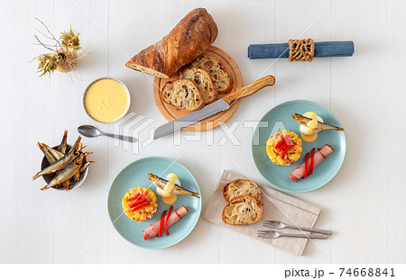 Henri Egg, tasty fresh brunch or snack. Henri Egg, tasty brunch or snack. Boiled eggs and smoked sprats fish with mayonnaise, ham and potato salad. White wooden table, no people. Henri Egg, tasty fresh brunch or snack. Henri Egg, tasty brunch or snack. Boiled eggs and smoked sprats fish with mayonnaise, ham and potato salad. White wooden table, no people. 74668841