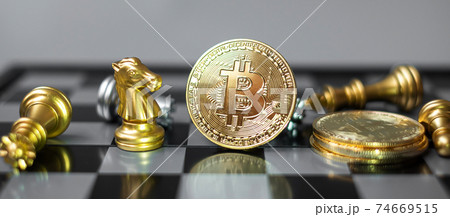 golden Bitcoin cryptocurrency coin stack and Chess piece on chessboard, Crypto is Digital Money of blockchain network, is exchanged using technology and online internet exchange. Financial concept golden Bitcoin cryptocurrency coin stack and Chess piece on chessboard, Crypto is Digital Money of blockchain network, is exchanged using technology and online internet exchange. Financial concept 74669515