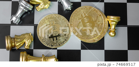 golden Bitcoin cryptocurrency coin stack and Chess piece on chessboard, Crypto is Digital Money of blockchain network, is exchanged using technology and online internet exchange. Financial concept golden Bitcoin cryptocurrency coin stack and Chess piece on chessboard, Crypto is Digital Money of blockchain network, is exchanged using technology and online internet exchange. Financial concept 74669517