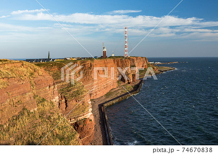 Helgoland, view of the cliff coast with lighthouse, North Sea, Schleswig-Holstein, Germany 74670838