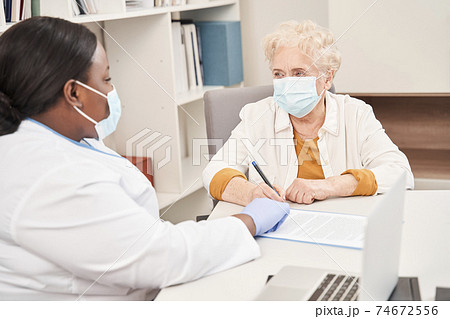 Physician consulting old female patient 74672556