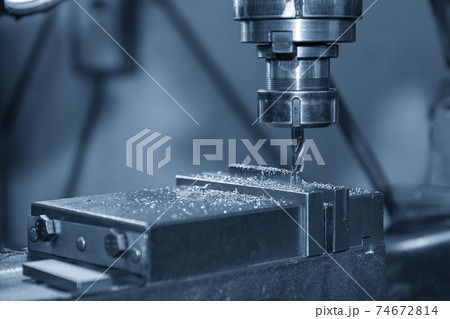 The NC milling machine drilling  at the metal part. 74672814