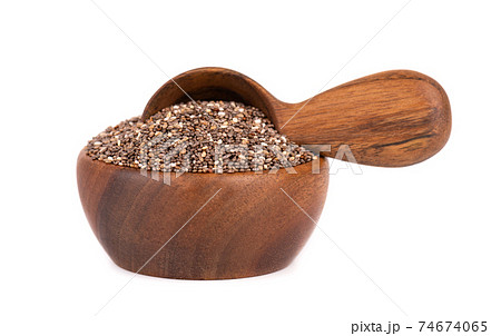 Chia seeds in wooden bowl and spoon, isolated on white background. Organic chia seeds. Chia seeds in wooden bowl and spoon, isolated on white background. Organic chia seeds. 74674065