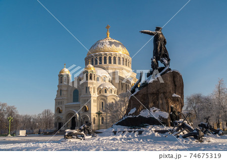 Russia. Kronstadt, February 9, 2021. St. Nicholas Naval Cathedral and the monument to S. O. Makarov on a frosty February day. Russia. Kronstadt, February 9, 2021. St. Nicholas Naval Cathedral and the monument to S. O. Makarov on a frosty February day. 74675319