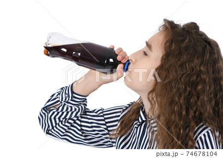 Child drinking Cola from bottle. 74678104