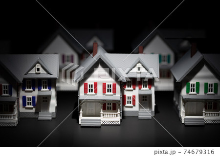 Several Model Houses In A Row With One Spot Lit In The Front Several Model Houses In A Row With One Spot Lit In The Front 74679316
