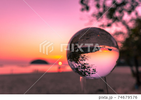 .Sunset view between the sea channel in the crystal ball 74679576