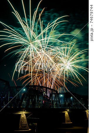 Colorful fireworks display and celebration for New year eve over iron bridge in Chiang Mai, Thailand. 74679744