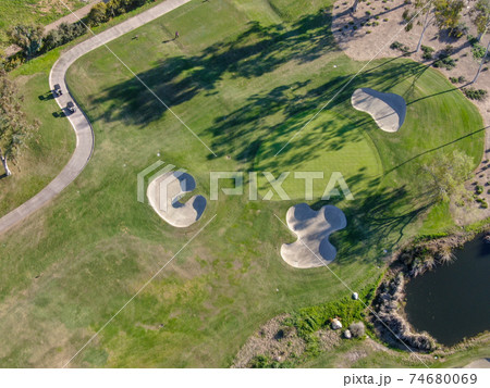 Aerial view over golf field. Aerial view over golf field. 74680069
