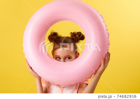 child girl in swimwear with inflatable rubber ring child girl in swimwear with inflatable rubber ring 74682916