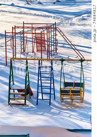 Children's playground in snowdrifts Children's playground in snowdrifts 74684817
