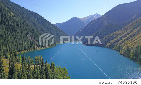 Kolsay lake among green hills and mountains. Kolsay lake among green hills and mountains. 74686190