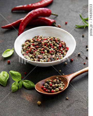 Red hot chili pepper corns and pods on dark background, top view Red hot chili pepper corns and pods on dark background, top view 74689033