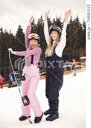 Girls snowboarding in the mountains with the snowboard 74691015