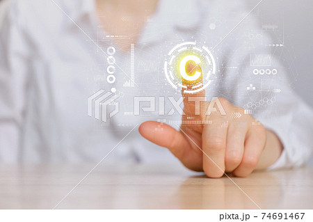 Copyright concept and hand pointing to an abstract sign with graphics. Copyright concept and hand pointing to an abstract sign with graphics. 74691467