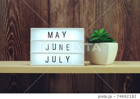 May, June, July word in light box on wooden background May, June, July word in light box on wooden background 74692182