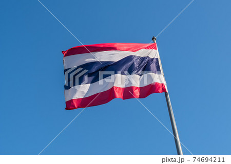 Thailand flag with blue sky as background Thailand flag with blue sky as background 74694211