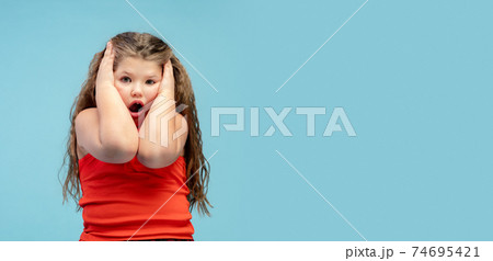 Happy caucasian little girl isolated on studio background. Looks happy, cheerful, sincere. Copyspace. Childhood, education, emotions concept Happy caucasian little girl isolated on studio background. Looks happy, cheerful, sincere. Copyspace. Childhood, education, emotions concept 74695421