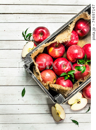 Red apples in a box. 74697147