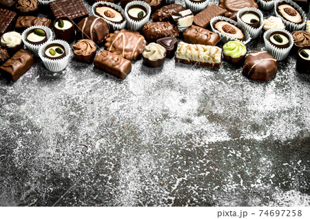 Chocolate candies. On rustic background. Chocolate candies. On rustic background. 74697258