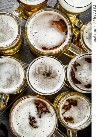Glasses with beer. On black chalkboard. Glasses with beer. On black chalkboard. 74697282