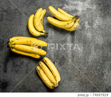 Fresh bunches of bananas. 74697929