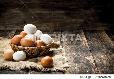Fresh eggs in a basket. 74698020