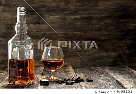 Cognac with bitter chocolate. Cognac with bitter chocolate. 74698152