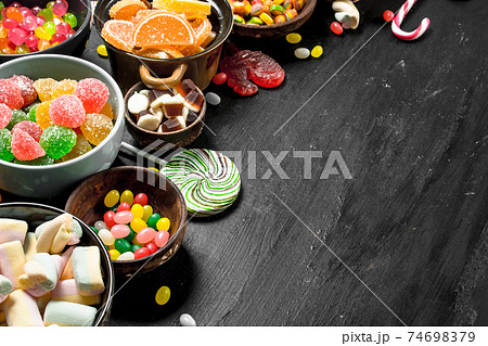 Different sweet candy, jelly and candied in a bowl. Different sweet candy, jelly and candied in a bowl. 74698379