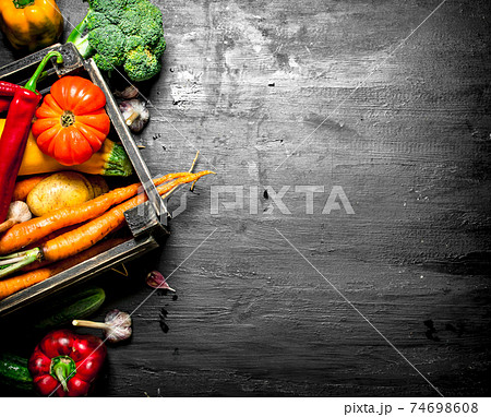 Organic food. Fresh vegetables in an old box. 74698608